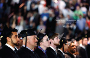 The first interior 2 page spread of the program, with a full page image of a row of students in profile, waiting to receive their degrees.