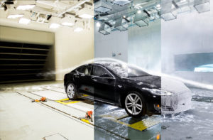 A composite image of a black Tesla car in the university's ACE climatic wind tunnel, being subjected to multiple environmental tests, from ice and snow, to rain, and extreme heat.